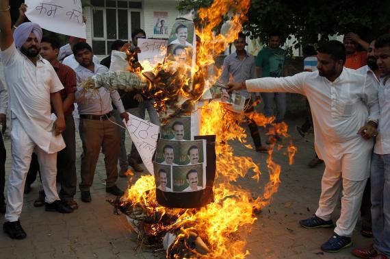 Activists of India's youth Congress burn an effigy of India's RM Gowda during a protest in Chandigarh