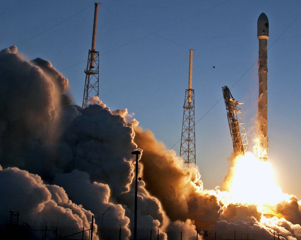 FILE - In this Feb. 11, 2015 file photo, a Falcon 9 SpaceX rocket lifts off from launch complex 40 at the Cape Canaveral Air Force Station in Cape Canaveral, Fla. In Texas, two internet billionaires whose strategies and personalities seem worlds apart are playing host to a 21st-century space race. Low-key Amazon founder Jeff Bezos' Blue Origin is in West Texas. Elon Musk, who helped start PayPal, heads high-profile SpaceX company 600 miles to the southeast. (AP Photo/John Raoux, File) TXKJ301