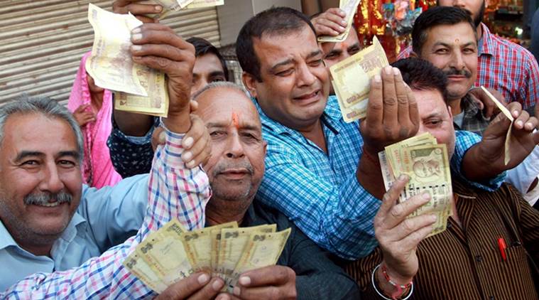 Jammu: Vaishno Devi pilgrims showing demonetized 500 and 1000 rupees notes in Jammu on Wednesday. PTI Photo (PTI11_9_2016_000308A)